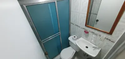 a bathroom with a shower and a toilet and a sink at Hotel Gran Imperio in Medellín