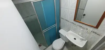 a bathroom with a shower and a toilet and a sink at Hotel Gran Imperio in Medellín