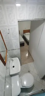 a bathroom with a toilet and a sink and a mirror at Hotel Gran Imperio in Medellín