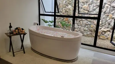 a bath tub sitting in front of a window at Hotel Piedras De Maní in Manizales