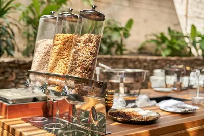 a table with three glass containers of cereal at Hotel Poblado Alejandria in Medellín