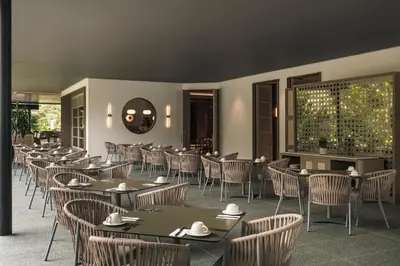 a restaurant with tables and chairs in a room at Hotel Poblado Plaza in Medellín