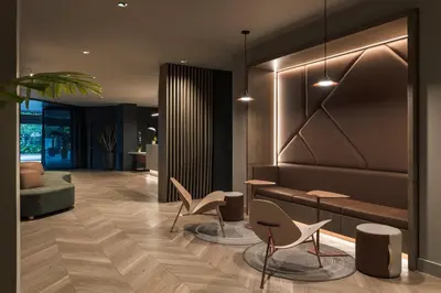 a lobby with chairs and a table and a couch at Hotel Poblado Plaza in Medellín