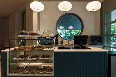 a kitchen with a counter with pastries and a mirror at Hotel Poblado Plaza in Medellín