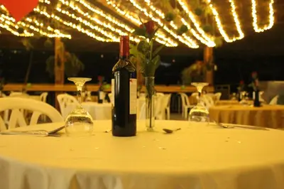 a bottle of wine sitting on a table with glasses at Rio Escondido in San Jerónimo