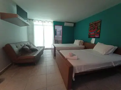 a hotel room with two beds and a couch at Rio Escondido in San Jerónimo