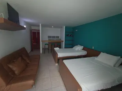 a hotel room with two beds and a couch at Rio Escondido in San Jerónimo
