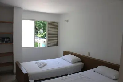 two beds in a room with a window at Rio Escondido in San Jerónimo