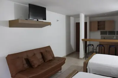 a living room with a couch and a kitchen at Rio Escondido in San Jerónimo