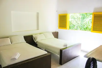 a room with two beds and a window at Rio Escondido in San Jerónimo