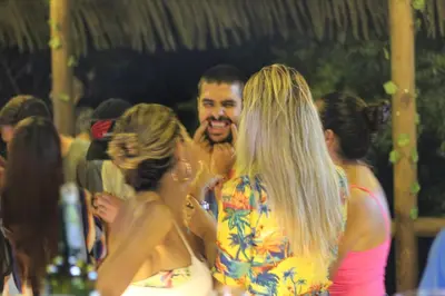 a group of people standing around in a party at Rio Escondido in San Jerónimo