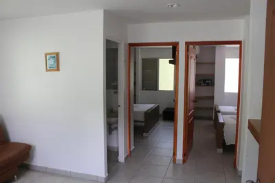 a bathroom with a tub and a sink in a room at Rio Escondido in San Jerónimo