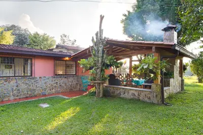 a house with a bar in the yard at La Casa de Piedra in Guatapé