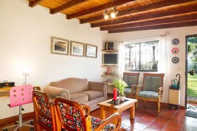 a living room with a couch and chairs at La Casa de Piedra in Guatapé