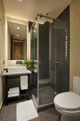 a bathroom with a shower and a toilet and a sink at 14 Urban Hotel in Medellín