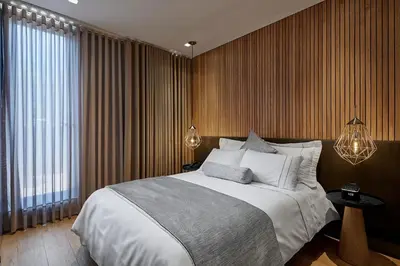 a bedroom with a large bed and a large window at 14 Urban Hotel in Medellín