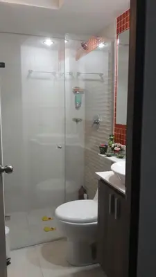 a bathroom with a shower and a toilet and a sink at Cerca al estadio familiar parqueadero piscina in Medellín