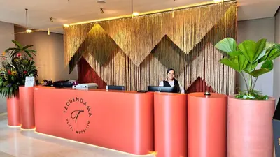 a woman standing at a desk in an office at Tequendama Hotel Medellín - Estadio in Medellín