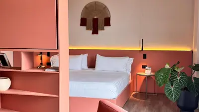 a hotel room with a bed and a desk at Tequendama Hotel Medellín - Estadio in Medellín