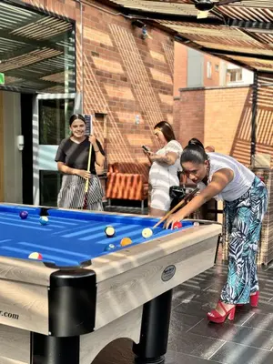a young boy playing with a pool table at Tequendama Hotel Medellín - Estadio in Medellín
