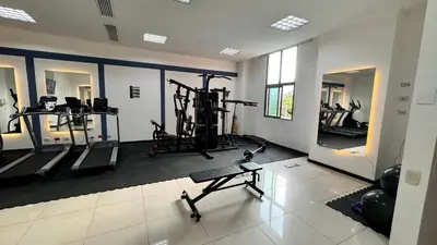 a gym with several treadmills and machines in it at Tequendama Hotel Medellín - Estadio in Medellín