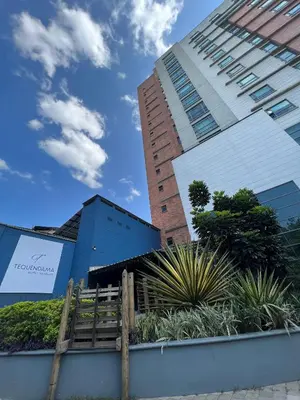 a building with a fence in front of it at Tequendama Hotel Medellín - Estadio in Medellín