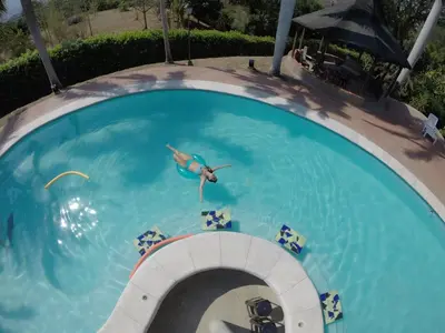 a person swimming in a swimming pool at Finca Galicia in Sopetran