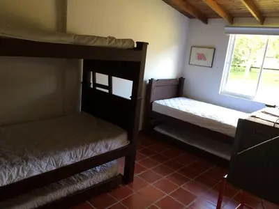 two bunk beds in a room with a window at Finca La Ranchera No. 1 in Tarso