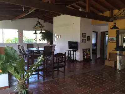 a dining room and living room with a table and chairs at Finca La Ranchera No. 1 in Tarso