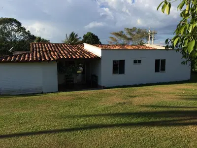 a small white house with a grass yard at Finca La Ranchera No. 1 in Tarso