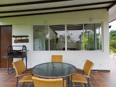 a glass table and chairs on a patio at Finca La Ranchera No. 2 in Tarso