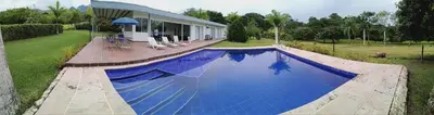a large blue swimming pool in front of a building at Finca La Ranchera No. 2 in Tarso