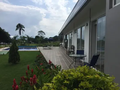 a patio with a table and chairs next to a house at Finca La Ranchera No. 2 in Tarso