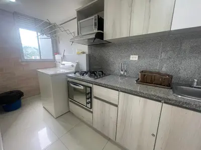 a kitchen with a sink and a stove top oven at Apartamento relajante, amplio, moderno e iluminado, Sabaneta, Medellín , 3 alcobas in Sabaneta