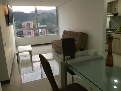 a living room with a glass table and a couch at Apartamento relajante, amplio, moderno e iluminado, Sabaneta, Medellín , 3 alcobas in Sabaneta