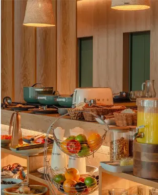 a buffet with a bowl of fruit on a table at The Charlee Hotel in Medellín