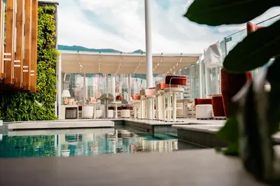 a swimming pool with a view of a city from a building at The Charlee Hotel in Medellín