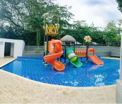 a swimming pool with a playground with a slide at Apartamento en Condominio in San Jerónimo