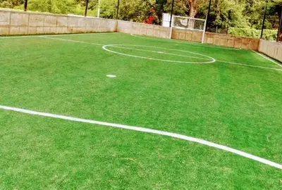 an artificial grass tennis court with white lines on it at Apartamento en Condominio in San Jerónimo