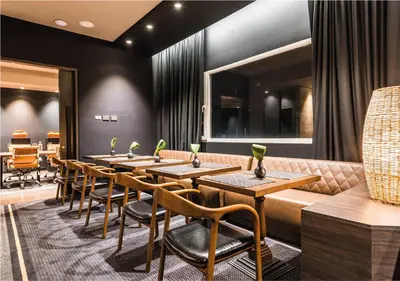 a row of tables and chairs in a restaurant at Movich Hotel Las Lomas in Rionegro