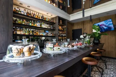 a bar with several dishes of pastries on display at Movich Hotel Las Lomas in Rionegro