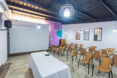 a conference room with a white table and chairs at Hotel Perlatto in Bello