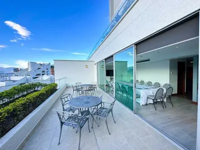 a patio with tables and chairs on a balcony at Hotel San Fernando Plaza in Medellín