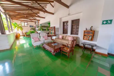 a living room with a green tile floor at Hotel Mariscal Robledo in Santa Fe de Antioquia