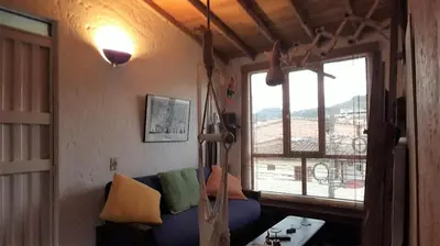 a living room with a blue couch and a window at Apartamento Acogedor en el Retiro in El Retiro