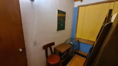 a small room with a wooden table and a chair at Apartamento Acogedor en el Retiro in El Retiro