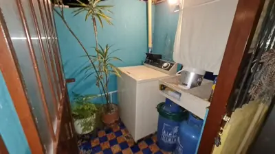 a small bathroom with a washing machine and plants at Apartamento Acogedor en el Retiro in El Retiro