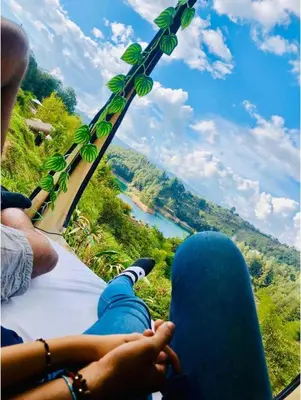 a person sitting on a bus looking out at a river at Levit Glamping - Hotel Guatapé Peñol in Guatapé