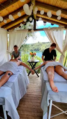 two women laying on beds in a tent at Levit Glamping - Hotel Guatapé Peñol in Guatapé