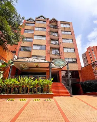 a tall building with a staircase in front of it at Hotel Casa Laureles in Medellín